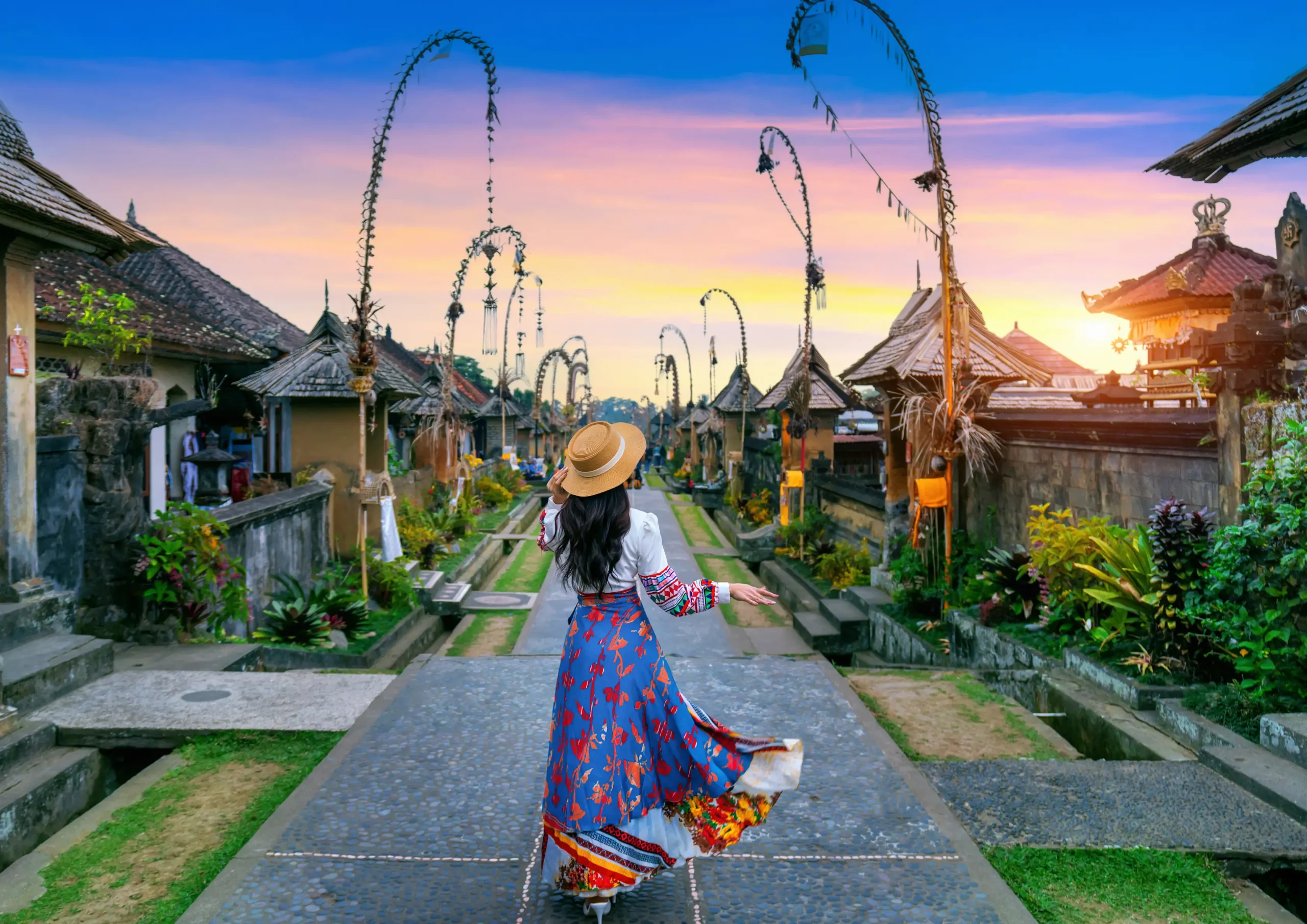 A solo female traveler confidently exploring a lush green walking trail in Ubud, Bali